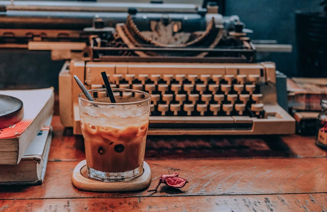 coffee in a cup near typewriter